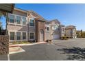 Exterior view of a residential building with stucco walls, a driveway, and manicured landscaping at 10001 Peace Way # 2228, Las Vegas, NV 89147