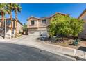 Charming two-story home features a three-car garage and shade tree at 1048 Painted Daisy Ave, Henderson, NV 89074