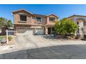 Charming two-story home features a three-car garage and desert rock landscaping at 1048 Painted Daisy Ave, Henderson, NV 89074