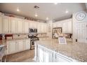 Spacious kitchen features granite countertops, a center island, stainless steel appliances, and custom cabinets at 1125 Via Canale Dr, Henderson, NV 89011