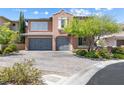 Charming two-story home with a paver driveway, attached garage, and tasteful desert landscaping at 12254 Cape Cortez Ct, Las Vegas, NV 89138