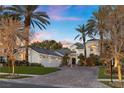 Elegant stucco home featuring mature landscaping, an attractive driveway, and a spacious three-car garage at 2337 Prometheus Ct, Henderson, NV 89074