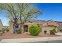 Charming single-story home with a tiled roof and solar panels plus low maintenance xeriscaped front yard at 2512 Desert Glen Dr, Las Vegas, NV 89134