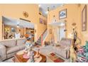 Comfortable living space featuring a staircase and warm, orange-painted walls at 2707 Commitment Ct, North Las Vegas, NV 89031