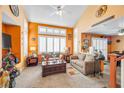 Inviting living room with plush seating, shutters, and warm, orange-painted walls at 2707 Commitment Ct, North Las Vegas, NV 89031