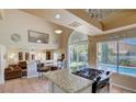 An open floorplan connects the kitchen to the living room and backyard pool access at 2714 Cricket Hollow Ct, Henderson, NV 89074