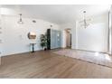 Bright and airy living room featuring modern lighting, sleek flooring, and minimalist decor with views to other rooms at 3300 Uribe St, Las Vegas, NV 89129