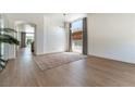 Open-concept living space with light wood floors, neutral walls, and large windows for plenty of natural light at 3300 Uribe St, Las Vegas, NV 89129