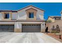 Two-story home featuring a neutral color scheme, a two-car garage, and a tile roof at 3365 Moon Eclipse St, North Las Vegas, NV 89032