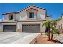 Two-story home featuring a neutral color scheme, a two-car garage, and a tile roof at 3365 Moon Eclipse St, North Las Vegas, NV 89032