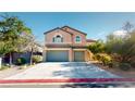 Charming two-story home boasts a three-car garage, mature trees, and beautiful desert landscaping at 3425 Fledgling Dr, North Las Vegas, NV 89084