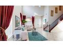 Inviting foyer features soaring ceilings, tile floors, grand staircase, and an abundance of natural light at 3425 Fledgling Dr, North Las Vegas, NV 89084