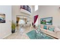 Bright living room features soaring ceilings, comfortable seating, and a formal dining area at 3425 Fledgling Dr, North Las Vegas, NV 89084