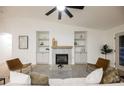 Comfortable living room with a fireplace, built-in cabinets, and stylish seating at 4016 Tyler William Ln, Las Vegas, NV 89130