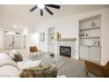 Bright and airy living room with a modern fireplace, built-in shelving, and stylish decor at 4016 Tyler William Ln, Las Vegas, NV 89130