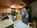Cozy kitchen with stainless steel appliances, light wood cabinets, and a stylish tile backsplash at 4748 Obannon Dr # C, Las Vegas, NV 89102