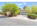Charming single-story home with a concrete driveway and mature trees in a lush front yard at 5705 Sovereign Way, Las Vegas, NV 89130