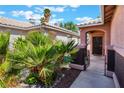 Inviting front entrance with lush greenery and wrought iron gated entry at 5978 Autumn Harvest Ave, Las Vegas, NV 89142