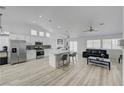 Open-concept kitchen featuring stainless steel appliances and a large island with bar seating at 6128 Casper Sands Ct, North Las Vegas, NV 89031