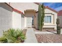 Front entrance with a desert landscape, security door and walkway to the front door at 6222 Eliza Ln, North Las Vegas, NV 89031