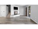 Bright living room showcasing a modern fireplace, hardwood style floors, and a view of the front entrance at 6442 Ironbark Ln, Las Vegas, NV 89107