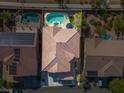 Aerial shot showcasing a backyard pool with lush landscaping and a tiled roof at 7125 Mountain Den Ave, Las Vegas, NV 89179