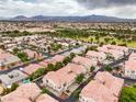 Gorgeous aerial view of the neighborhood, showcasing the beautiful terracotta roofs and lush trees at 7450 S Eastern Ave # 2073, Las Vegas, NV 89123