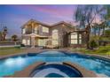 Inviting backyard pool and hot tub with covered seating and manicured lawn at 7520 Captains Harbor Dr, Las Vegas, NV 89117