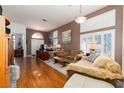 Spacious living room with hardwood floors, ample seating, and natural light at 7815 Windward Rd, Las Vegas, NV 89147