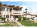 Charming condo complex featuring well-kept grounds, mature trees, and stucco siding at 7932 Diamond Rock Way # 101, Las Vegas, NV 89128