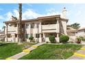 Attractive condo building showcasing well-maintained landscaping and stucco facade at 7932 Diamond Rock Way # 101, Las Vegas, NV 89128