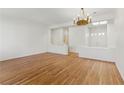 Spacious living room with hardwood floors, ample natural light, and a stylish chandelier, perfect for relaxation at 8114 Lapis Harbor Ave, Las Vegas, NV 89117