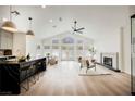 Open-concept living area with high ceilings, hardwood floors, fireplace and backyard view at 8140 Bay Harbor Dr, Las Vegas, NV 89128