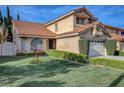 Charming two-story home showcasing a well-maintained lawn, mature trees and a two-car garage at 8236 Bermuda Beach Dr, Las Vegas, NV 89128