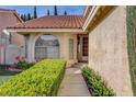 Inviting single-Gathering home showcasing a mature lawn, lush hedges, and beautiful landscaping at 8236 Bermuda Beach Dr, Las Vegas, NV 89128