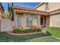 Lovely home with an arched window and a lush lawn accented with blooming flowers at 8236 Bermuda Beach Dr, Las Vegas, NV 89128