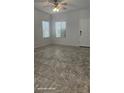 Bright living area featuring tile flooring, natural light, and a ceiling fan at 8928 Hand Painted Ct, Las Vegas, NV 89149