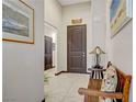 Bright hallway featuring stylish doors, tile floors, and tasteful decor, creating a welcoming ambiance at 961 Cutter St, Henderson, NV 89011