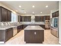 Modern kitchen with granite countertops, stainless steel appliances, and a central island at 9655 Shadow Cliff Ave, Las Vegas, NV 89166