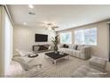 Bright, open-plan living room with a large window, ceiling fan, and tile flooring at 9655 Shadow Cliff Ave, Las Vegas, NV 89166