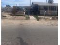 Front view of a single-Gathering home, with a gated front yard, driveway, and covered front porch at , Las Vegas, NV 89104