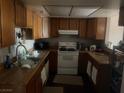 The kitchen features wooden cabinets and is equipped with essential appliances for convenient meal preparation at , Las Vegas, NV 89115