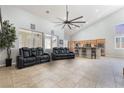 Open-concept floorplan, high ceilings, tiled floors, connecting the living room and kitchen at 10259 Wolves Den Ln, Las Vegas, NV 89178