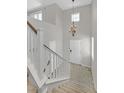 Bright entryway featuring high ceilings, tile flooring, and a staircase with white railings at 1121 Via Castelli, Henderson, NV 89052
