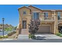 Charming two-story townhome featuring a balcony, two-car garage, and landscaped front yard at 1121 Via Castelli, Henderson, NV 89052