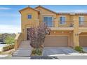 Two-story home featuring a balcony, attached garage, and well-manicured landscaping at 1121 Via Castelli, Henderson, NV 89052