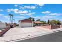 Charming single-story home with a well-maintained lawn, and palm trees, perfect curb appeal at 1534 Irene Dr, Boulder City, NV 89005
