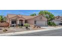 Beautiful one-story home with a front yard featuring low-water landscaping and a spacious two-car garage at 1931 Jasper Creek Pl, Las Vegas, NV 89123