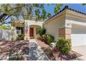 Beautiful single-story home with a two-car garage, desert landscaping and a covered front entryway at 1945 Trail Peak Ln, Las Vegas, NV 89134