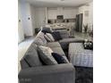 Comfortable living room featuring a sectional sofa with throw pillows and modern decor at 219 Vanhoy Ave, Henderson, NV 89011